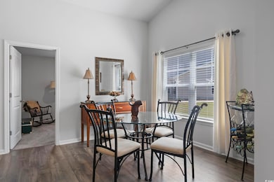 Dining space with baseboards and dark wood-style f