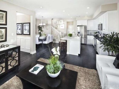 Great room through kitchen (model home shown, actu