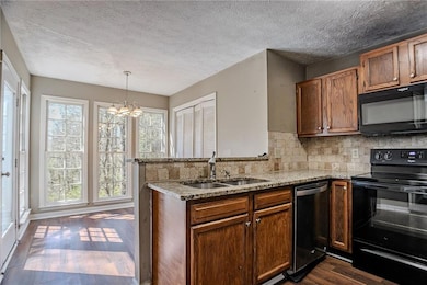 Kitchen with a sink, a peninsula, plenty of natura