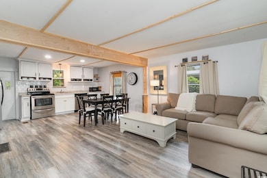 Living room with light hardwood / wood-style floor