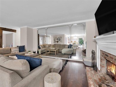 Living room with ornamental molding, wood-type flo