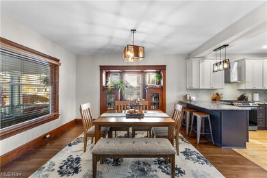 Dining space featuring dark wood-type flooring and a chandelier