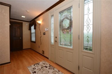 The large foyer boast an artfully beveled glass do