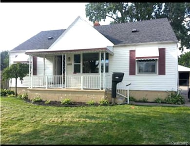 Bungalow-style house with covered porch and a front lawn