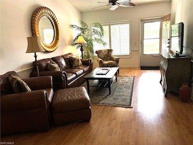 Living room featuring ceiling fan, a textured ceil