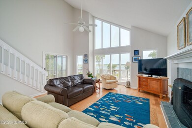 Open LR w/ fireplace & vaulted ceiling