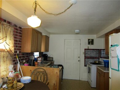 Unit #1 Eat In Kitchen, door to rear covered porch