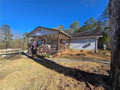 View of front facade with a porch, a front lawn, cooling unit, and crawl space