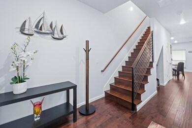 Stairs featuring wood finished floors and recesse