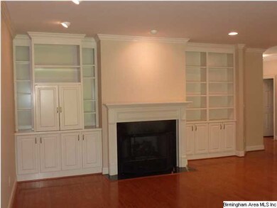 Built-in bookcases surround the fireplace in the l