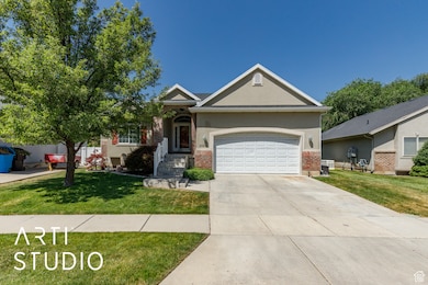 View of front of property with brick siding, an attached garage, driveway, and a front yard