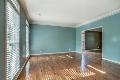 This is a great big room. Lots of sunlight, tall ceilings and beautiful crown moldings that continue throughout the first floor. 