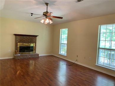 Living Room with Raised Hearth Wood Burning Fireplace.