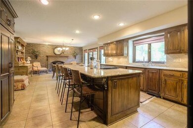 Massive granite island and built in fridge greet y