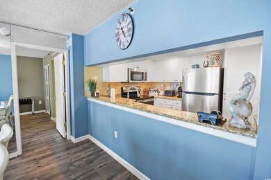 Kitchen with baseboards, light stone countertops, 