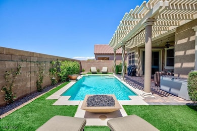 View of swimming pool with a pergola, ceiling fan,