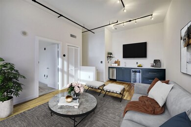 The media room with oak wood floors is located ups