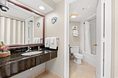 Bathroom with a sink, toilet, tile patterned floors, and shower / bath combination with curtain