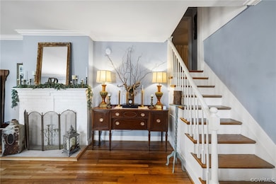 Staircase with a brick fireplace, dark hardwood /