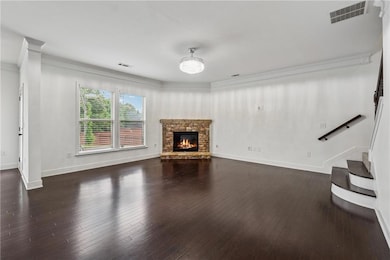 Unfurnished living room featuring ornamental moldi