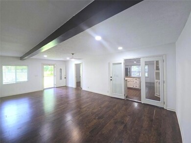 Unfurnished living room featuring recessed lighting, dark wood-style flooring, ceiling fan, baseboards, and beam ceiling