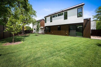 Back of property featuring a fenced backyard, a s