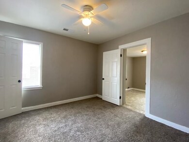 Unfurnished bedroom featuring carpet floors, baseboards, and ceiling fan
