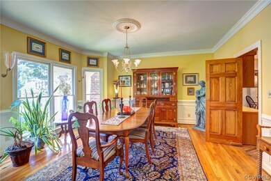 Sunny Dining Room with wood floor, picture trim mo