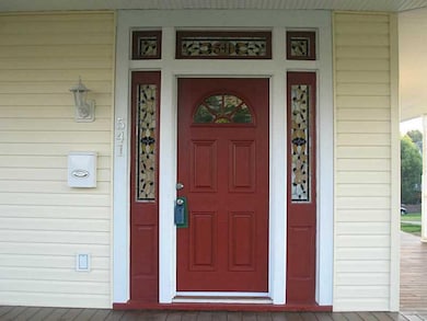 Exterior Front. Inviting stained glass surrounds f