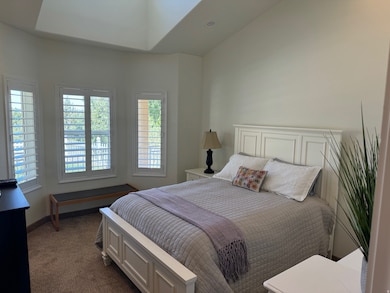 Bedroom featuring dark carpet and baseboards