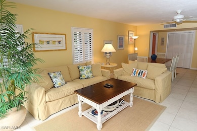Living area with light tile patterned floors and c