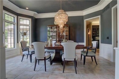 Elegant formal dinning room with bay window and bu