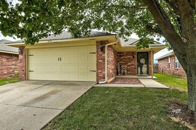 Ranch-style house with a garage and a front yard