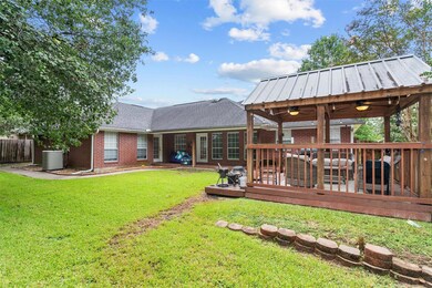 View of yard with a wooden deck and ceiling fan