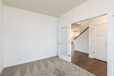 (Actual photo of the home)  Located just off the foyer, this main level flex room provides endless opportunities; including a home office, formal dining area, a playroom or another sitting room.