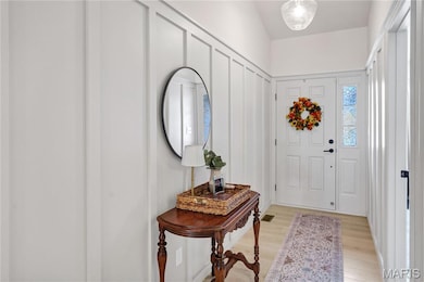 Gorgeous Board & Batten & Seeded Glass Pendant Lighting Highlight the Vaulted Foyer