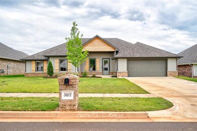 View of front of house with a garage and a front y
