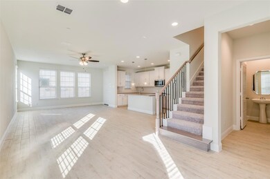 Living room with sink, ceiling fan, and light hard
