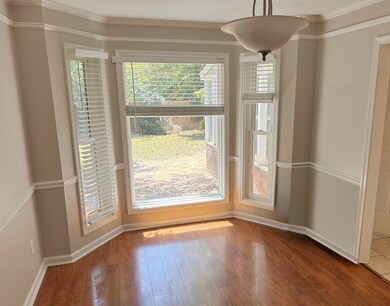 Unfurnished dining area featuring wood-type floori