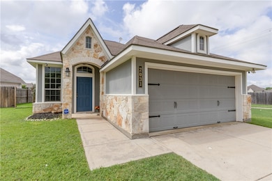 View of front of home with stone siding, an attach