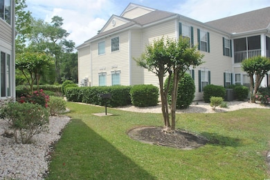 View of side of property featuring a lawn and central AC unit