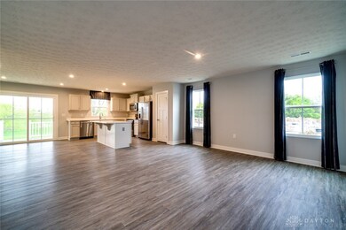 Open living and kitchen area with luxury vinyl pla