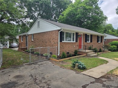 Single story home with a gate and brick siding