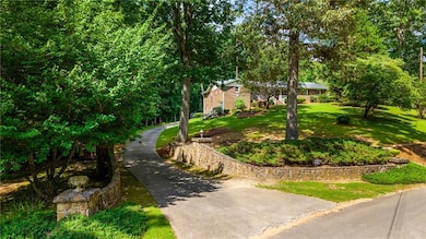 View of grassy yard featuring driveway