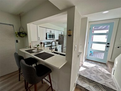 Kitchen featuring white cabinets, appliances with