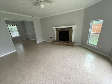 Unfurnished living room with healthy amount of natural light, tile patterned flooring, a ceiling fan, a chandelier, and a textured ceiling