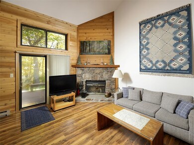 Beautiful wood floor and stone woodburning firepla