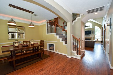 The wrought iron staircase blends into the middle of the home.