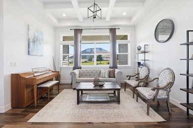 Sitting room with coffered ceiling, dark wood-style floors,  and recessed lighting