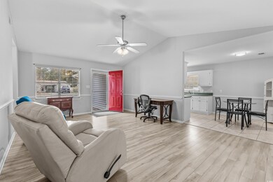 Living room featuring ceiling fan, light hardwood 